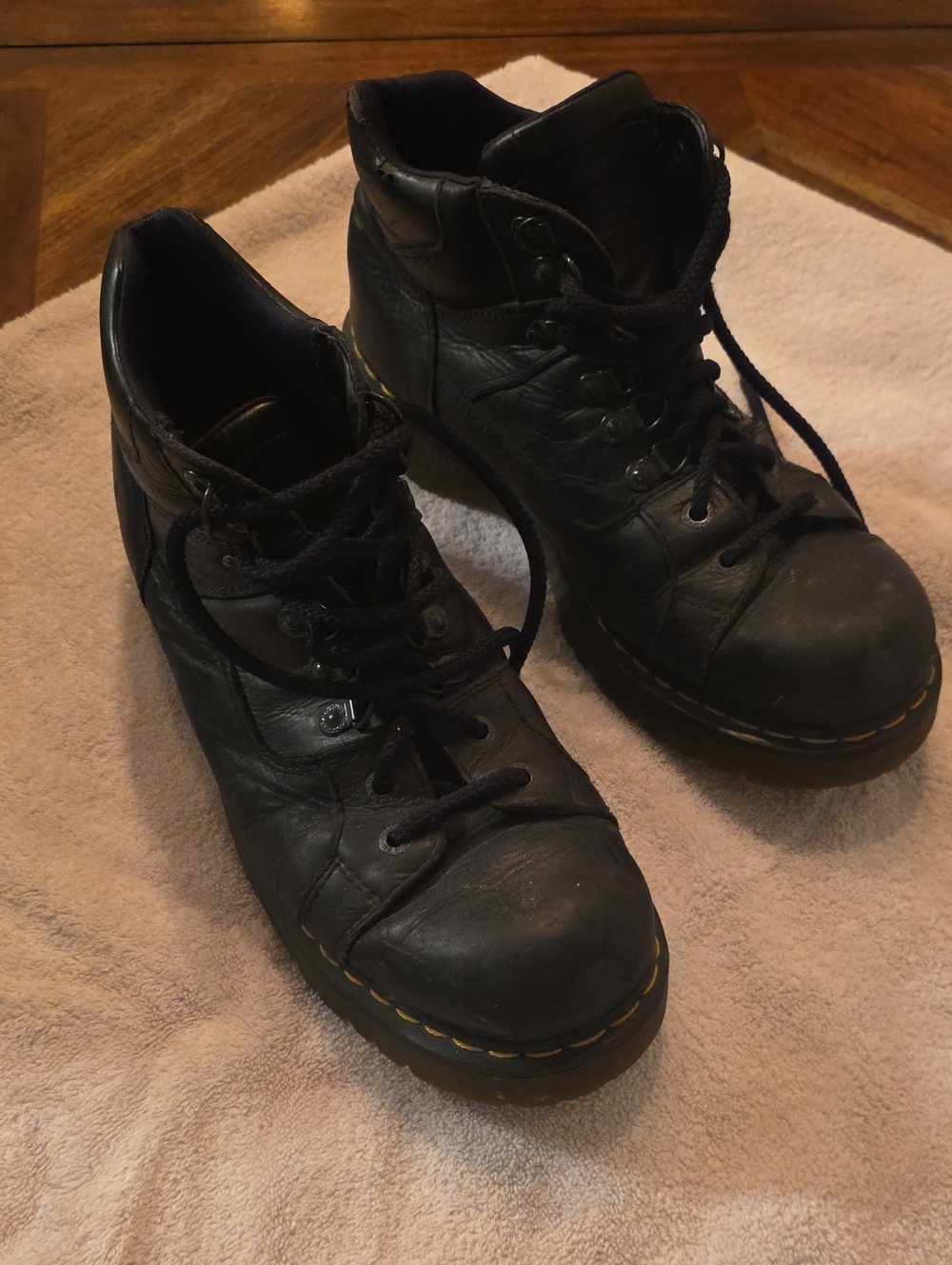 Dr. Martens Black Leather Lace-Up Ankle Boots with Yellow Stitching.